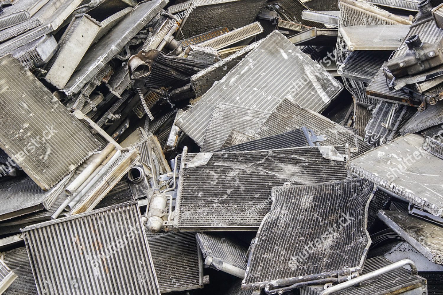 Heap of used aluminum radiators stacked in a scrap yard for recycling